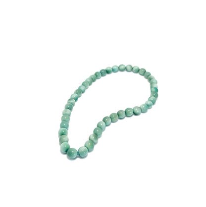 English Green tagua beaded necklace on a white background