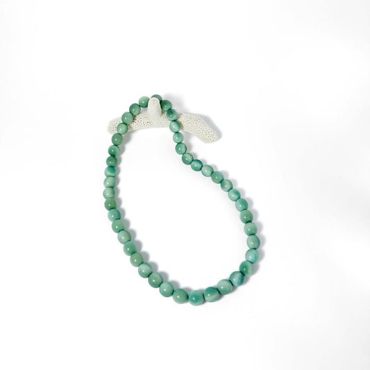 Green beaded tagua necklace on a white background